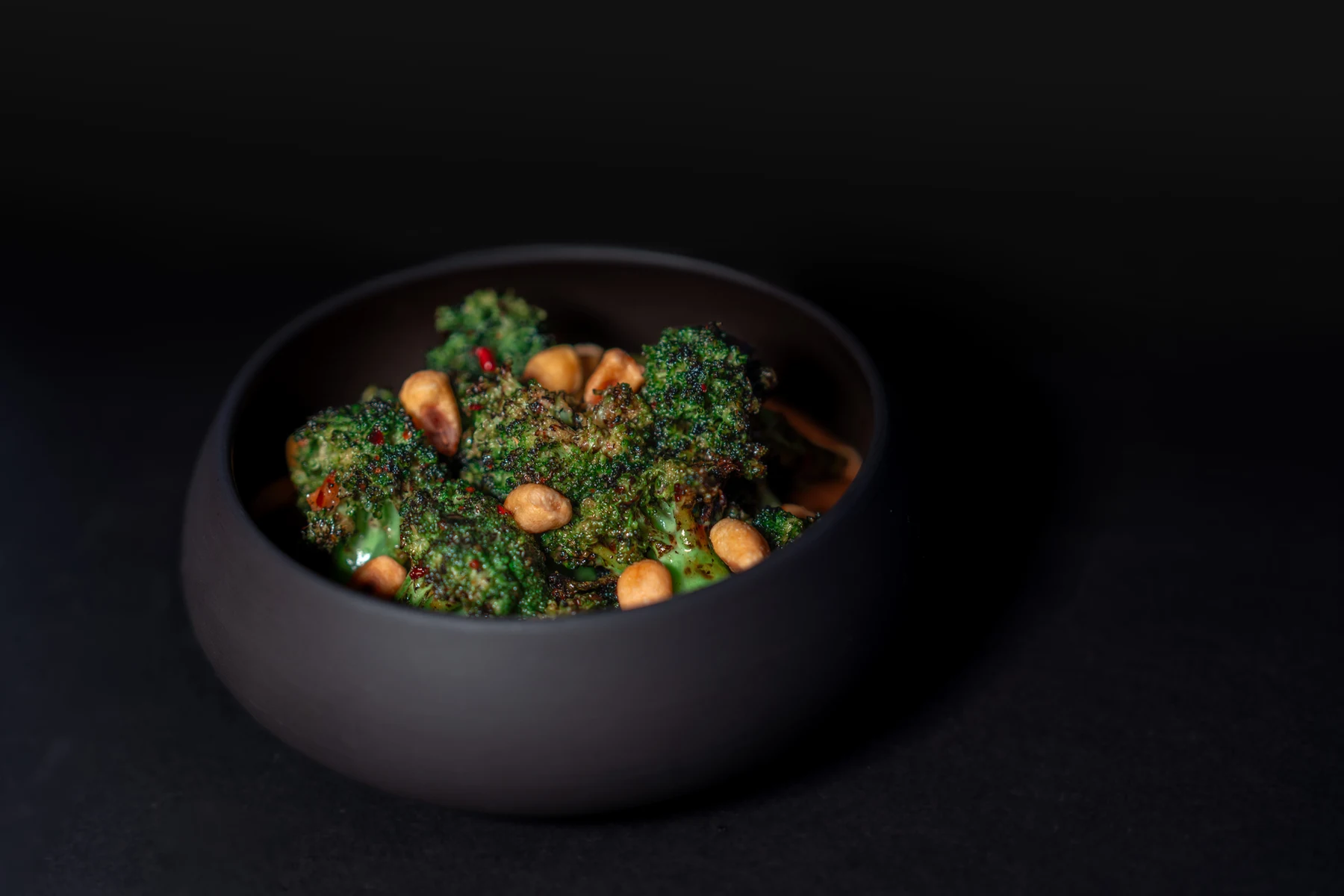 A dark bowl containing a finished Mirin dish