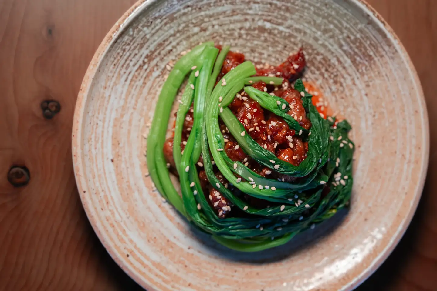 A plated green vegetable dish at Mirin