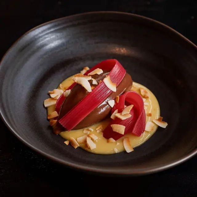Illustrative dark chocolate cremeux with rhubarb and coconut