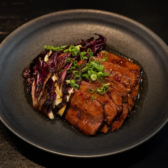 Illustrative hot and sour veal tongue with pickled radicchio